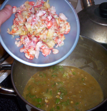 Adding the crawfish meat to the stew matrix, which is an amazing yellowish-orangish color thanks to the crawfish fat